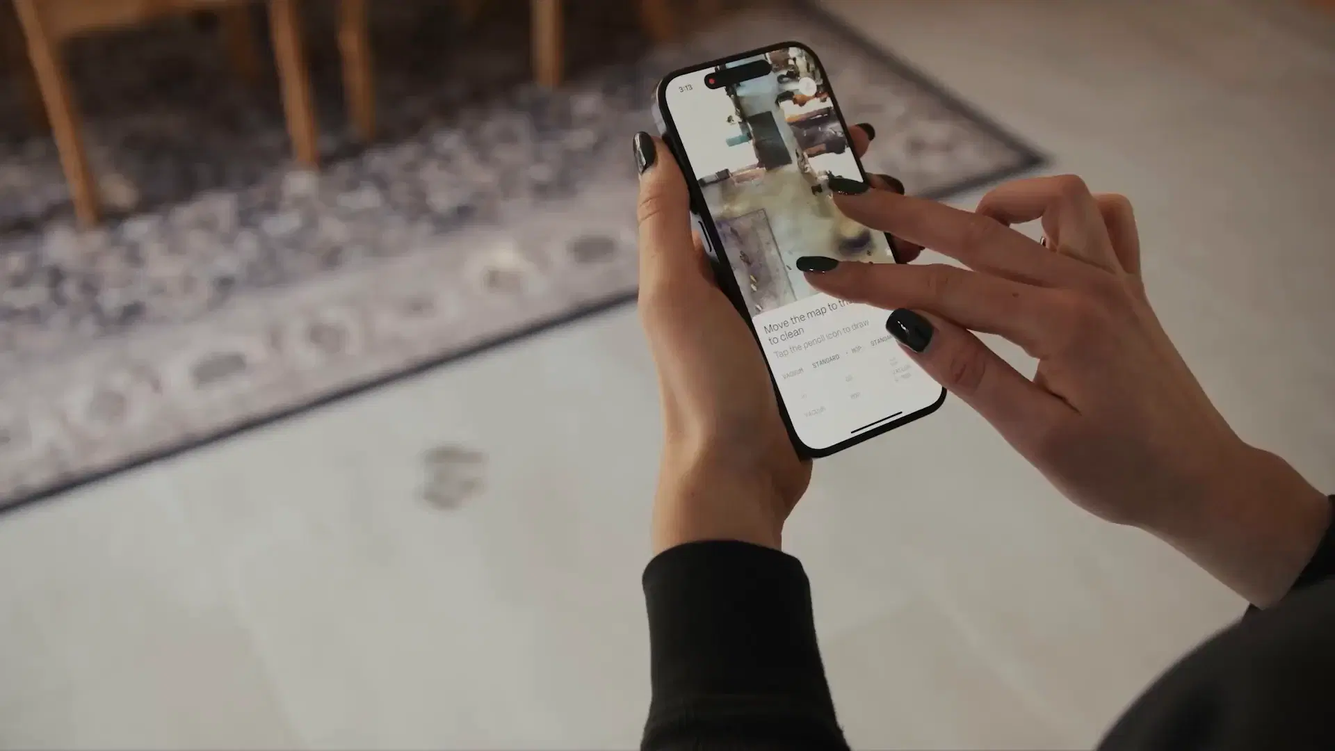 Two hands marking a spot to clean on the map in the Matic app