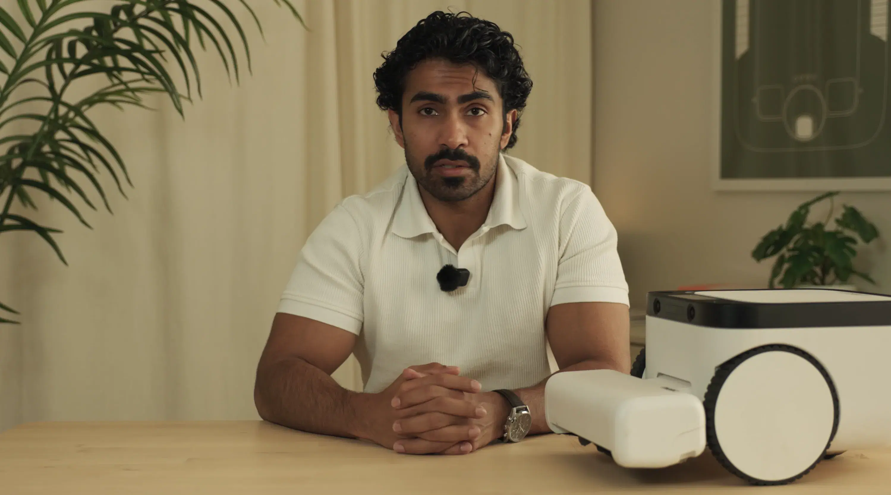 Matic's head of hardware speaking at a desk beside a Matic robot