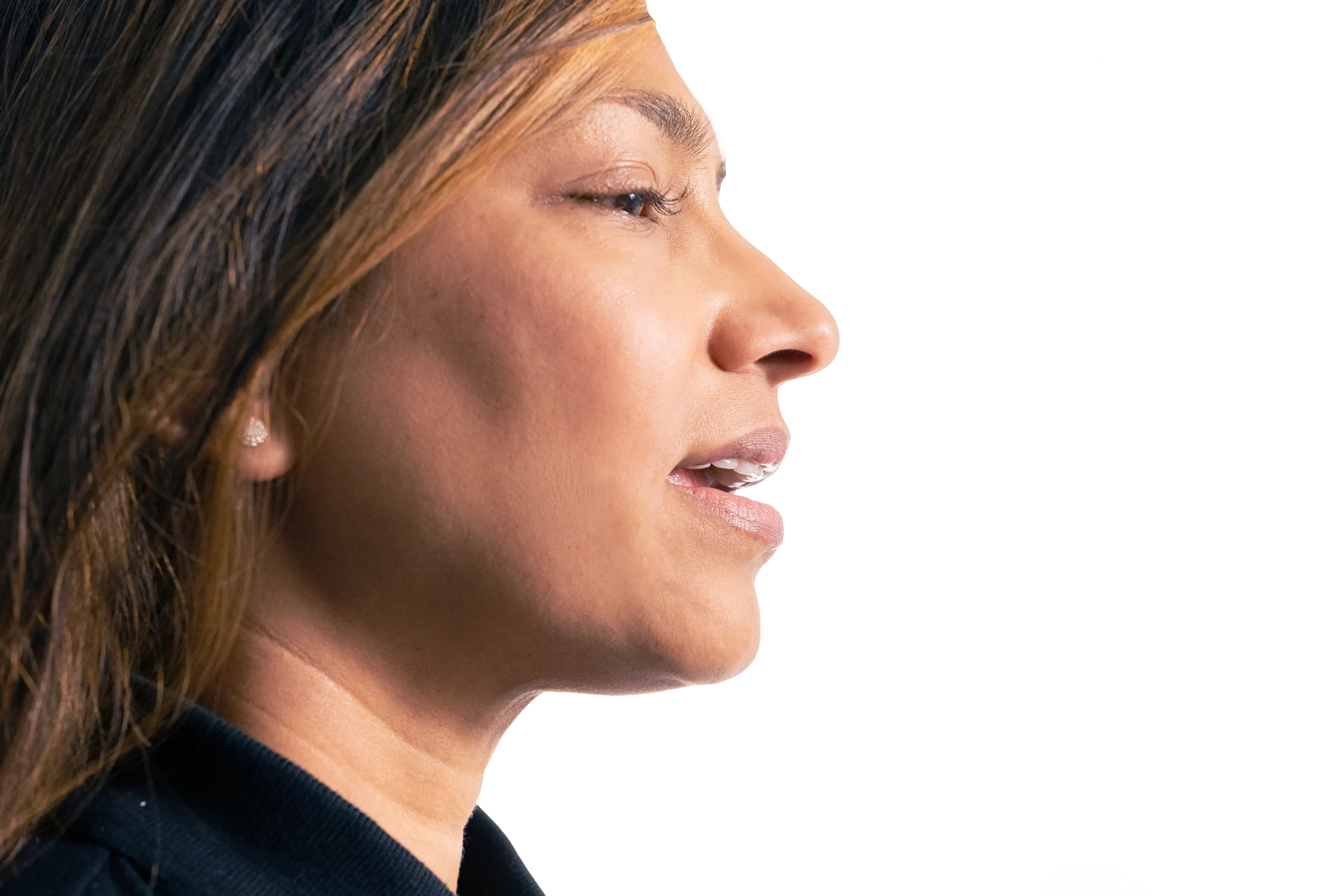 A woman speaking, in profile