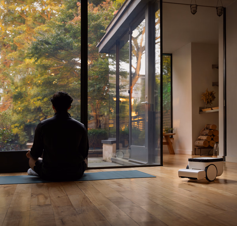 Matic cleaning quietly while someone does yoga